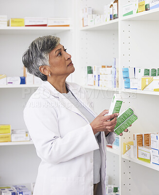 Buy stock photo Senior pharmacist woman, shelf and boxes with thinking, packing stock and inventory inspection. Mature pharmacy manager, package or product for wellness, health or ideas with drugs in retail store