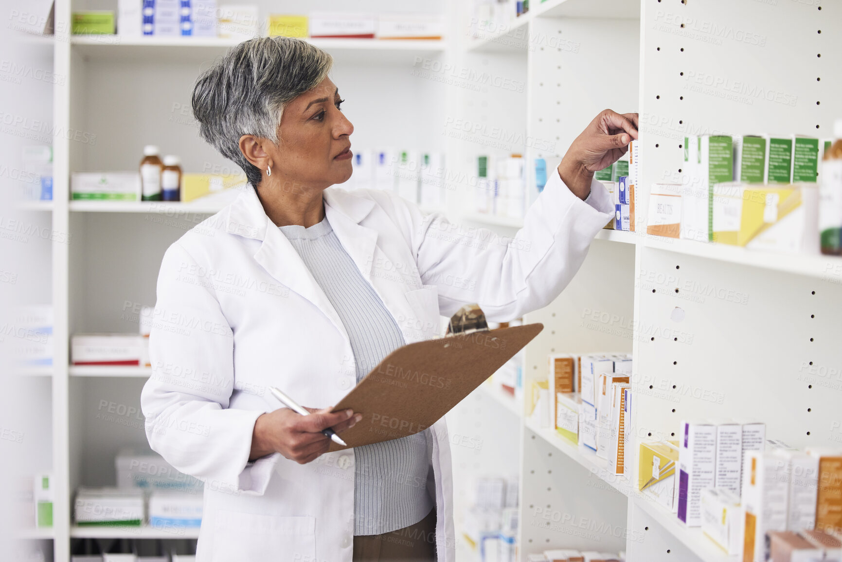 Buy stock photo Pharmacy, writing and clipboard of woman with medicine on a shelf for pharmacist inventory. Mature female employee in healthcare, pharmaceutical and medical industry reading information on stock
