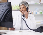 Pharmacist, telephone and computer for prescription with woman in conversation for retail healthcare. Female chemist, working and computer with customer service or medicine with drug database.