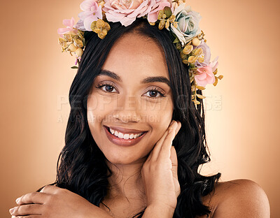 Buy stock photo Portrait, skincare and flower crown with a model woman in studio on a brown background for shampoo treatment. Face, smile or beauty with a happy young person looking confident about natural cosmetics