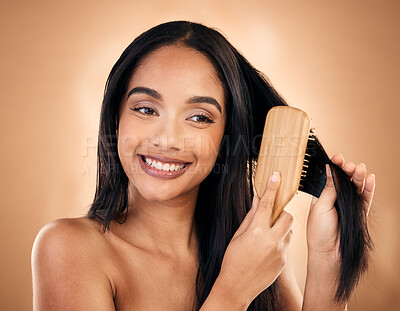 Buy stock photo Hair care, brush and happy woman with beauty isolated on a brown background in studio. Salon, smile and model with a wood grooming product for natural aesthetic, hairdresser or hairstyle for wellness