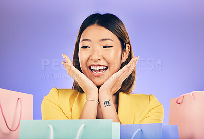 Buy stock photo Happy, face and woman with shopping bag from a sale, promotion or customer with deal on retail clothing. Surprise, face and Asian model with smile emoji or crazy discount on luxury product or store