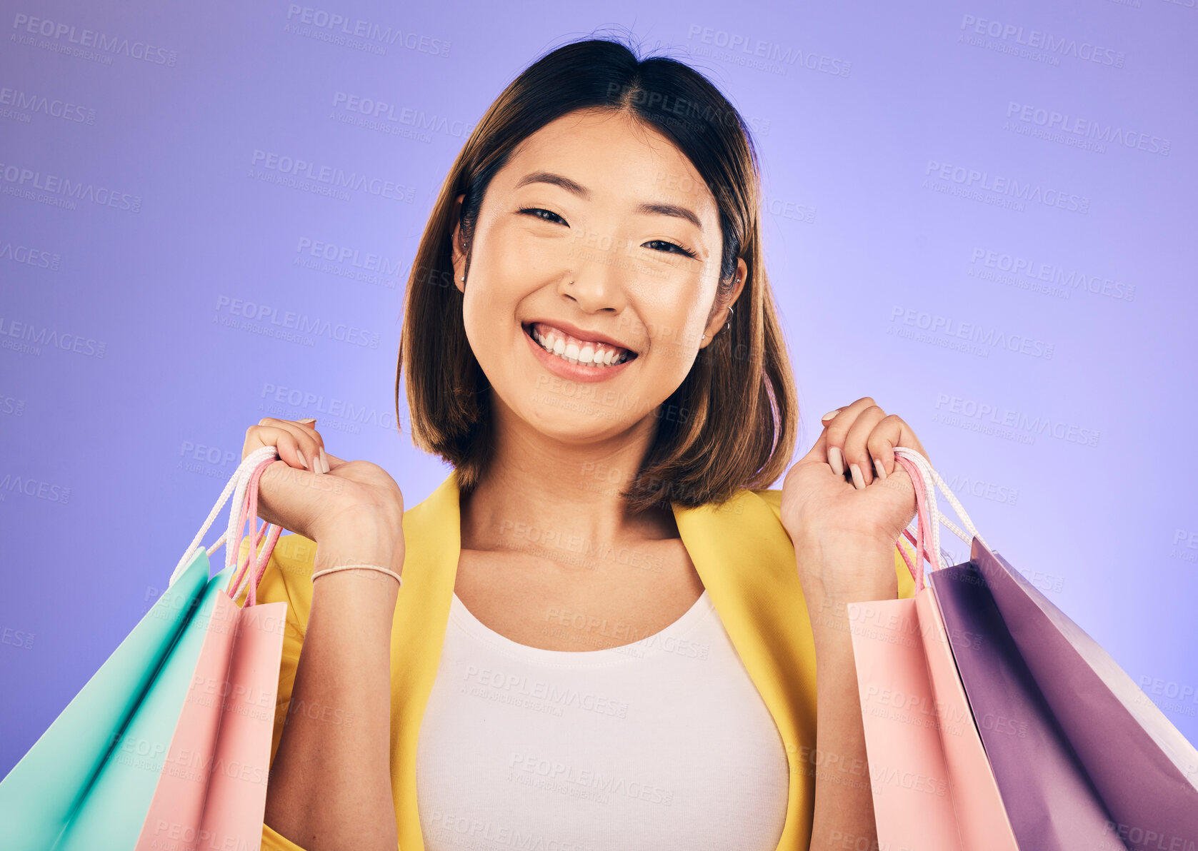 Buy stock photo Happy woman, portrait and shopping bag with retail and fashion, commerce and sale on purple background. Discount at boutique shop, Asian female customer and market with store promotion in studio