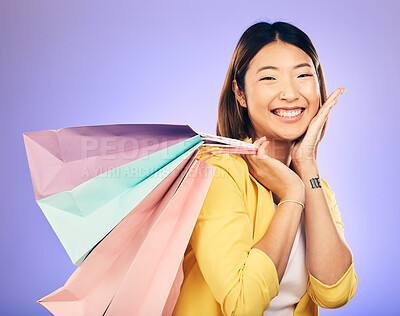 Buy stock photo Happy, portrait and woman with shopping bag, retail and commerce with fashion sale on purple background. Discount at boutique shop, Asian female customer and market with store promotion in studio
