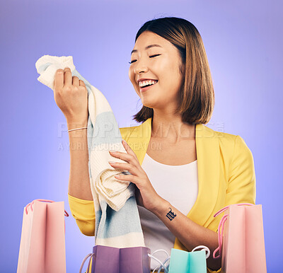 Buy stock photo Clothes, shopping bag and happy woman with product sale, discount or promotion on a studio, purple background. Excited young model, asian person or customer fashion choice, retail and e commerce gift