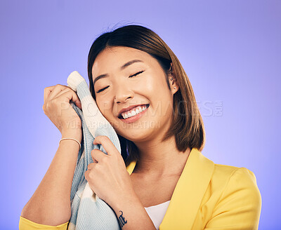 Buy stock photo Woman, soft jersey and smile in studio with fashion choice, quality fabric and happy by purple background. Young Japanese designer, material and excited with product, touch skin and pride in career