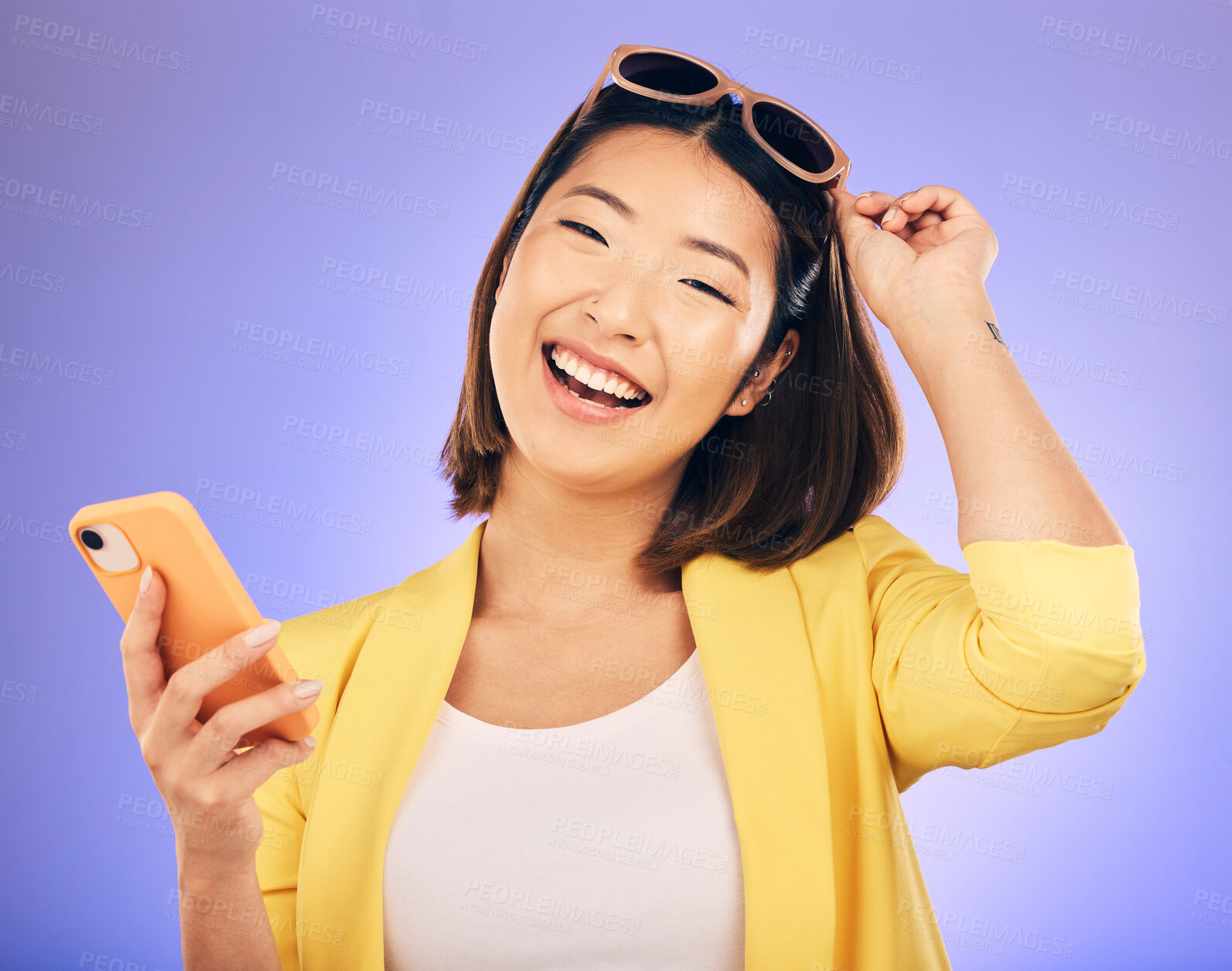 Buy stock photo Happy asian woman, portrait and phone in fashion for communication against a purple studio background. Female person or model with smile for networking or stylish clothing on mobile smartphone app