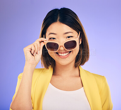 Buy stock photo Happy asian woman, portrait and sunglasses for fashion or stylish accessory against a purple studio background. Female person or model with smile in satisfaction or relax for summer style or clothing