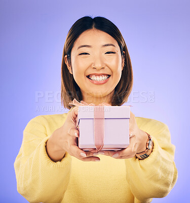 Buy stock photo Portrait, smile and Asian woman with a gift, box and celebration against a studio background. Face, happy female person or model with happiness, present and giveaway with a ribbon, surprise and prize