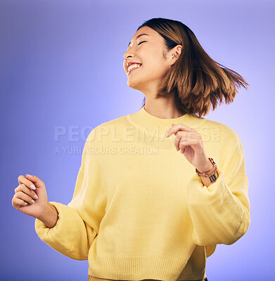 Buy stock photo Happy asian woman, dance and music in freedom or casual fashion against a purple studio background. Female person or model smile enjoying energy, event or party in happiness for clothing on mockup