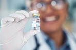 Healthcare, hands and vaccine with medicine bottle and doctor in blurry background . Innovation, vaccination and medical professional with container for treatment for prevention or cure for safety.