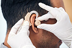 Hearing aid, man and doctor hands with patient consultation for ear and wellness at hospital. Help, employee and medical test of physician with health insurance and consulting exam with expert