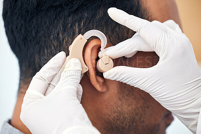 Buy stock photo Hearing aid, man and doctor hands with deaf patient consultation for ear and wellness at hospital. Help, employee and ear test of physician with tinnitus and consulting exam with healthcare expert