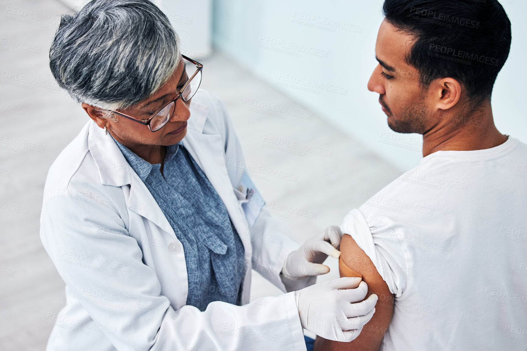 Buy stock photo Doctor, arm and man with plaster for vaccine, healthcare protection and safety from virus in clinic. Consultation, patient and woman medical professional in hospital for vaccination or medicine cover