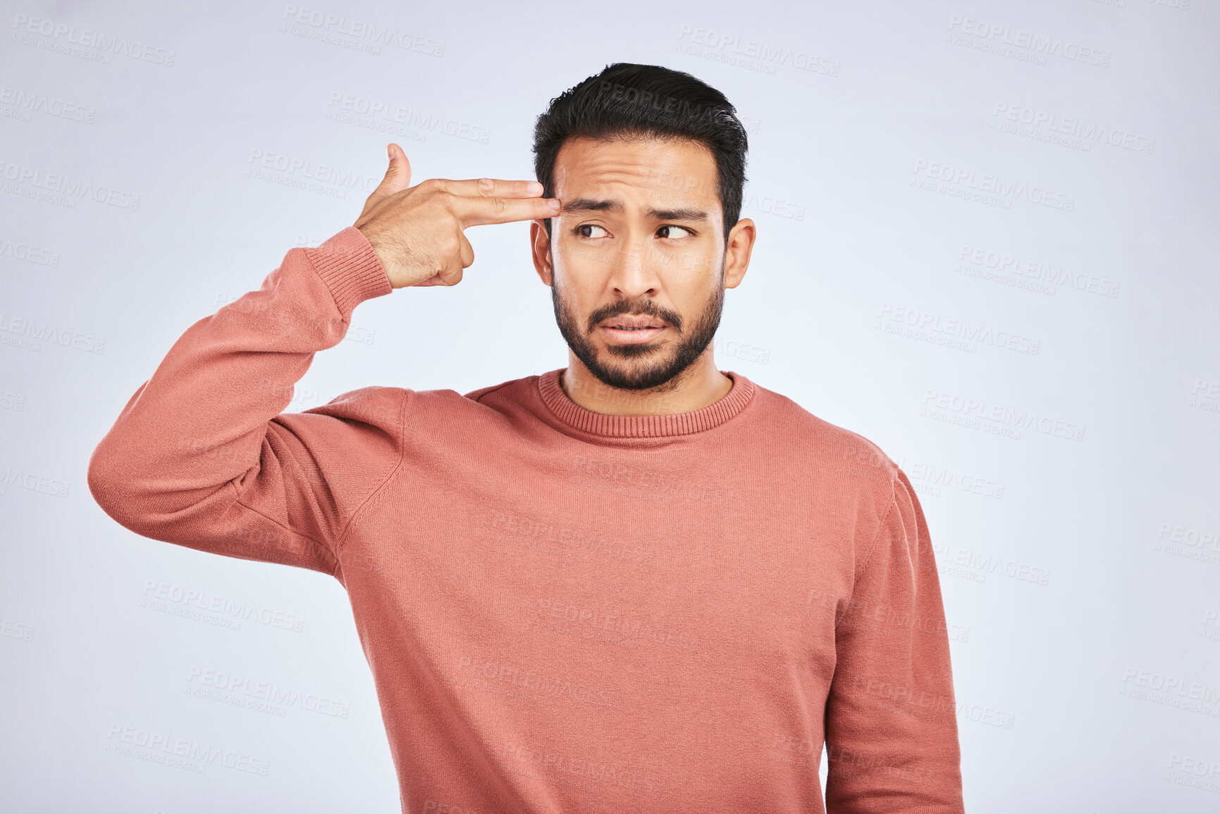 Buy stock photo Frustrated, depression and man with gun gesture or stress with mental health or emotion in grey background in studio. Male person, shooting and head with anger or problem with anxiety and fear.
