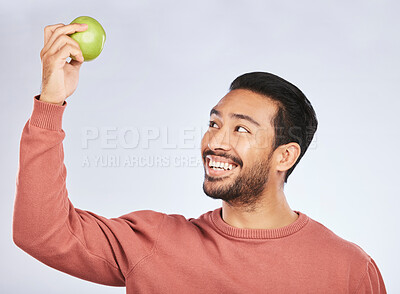 Buy stock photo Studio smile, happy and man with apple product for weight loss diet, healthy lifestyle change or body nutrition goals. Eating wellness food, nutritionist fruit and hungry person on white background

