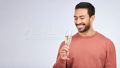 Buy stock photo Champagne, celebration and asian man with glass in studio for success, milestone or victory on grey background. Wine, happy and male winner celebrating promotion, announcement or competition giveaway