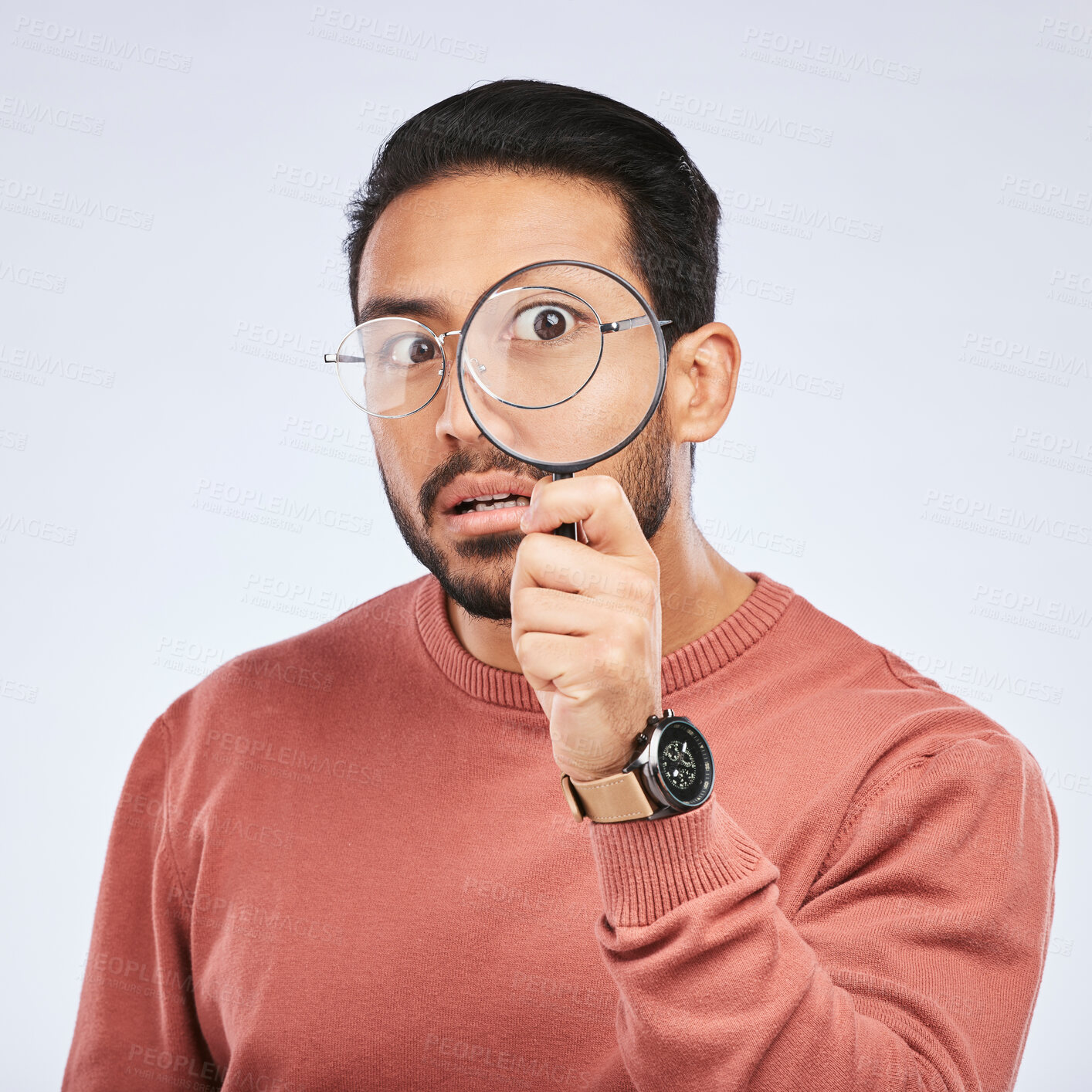 Buy stock photo Magnifying glass, man and focus in a studio with investigation for clues on crime. Isolated, white background and male person with inspection for scam, evidence and information on a job with shock