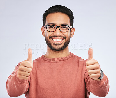 Buy stock photo Thumbs up, portrait and man with glasses for success in studio, white background and winning news. Happy asian male model, ok emoji and like of feedback, review and vote yes in agreement of promotion
