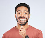 Magnifying glass, mouth and portrait of a man with a smile for teeth, beauty or dental hygiene. Happy, healthy and an Asian person or model with gear to show oral care results on a white background