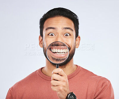 Buy stock photo Magnifying glass, mouth and portrait of a man with a smile for teeth, beauty or dental hygiene. Happy, healthy and an Asian person or model with gear to show oral care results on a white background