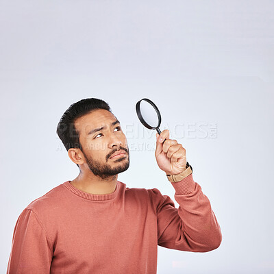 Buy stock photo Magnifying glass, man and serious in a studio with investigation for clues. Isolated, white background and male person with inspection for scam, crime evidence and information search with mockup