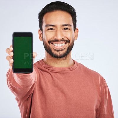Buy stock photo Phone, green screen and portrait of asian man with mockup for app, menu or checklist on grey background. Space, display and face of male person with smartphone platform for social media or networking
