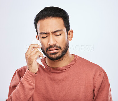 Buy stock photo Depression, crying and sad asian man in studio with tissue, criss or broken heart on grey background. Stress, mistake and face of male person with tears for anxiety, trauma or crisis, regret or fail