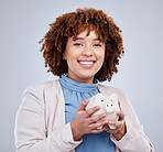Portrait, piggy bank and happy woman in studio for savings, growth and budget on grey background. Money, box and face of female person with investment success, smile and future financial freedom