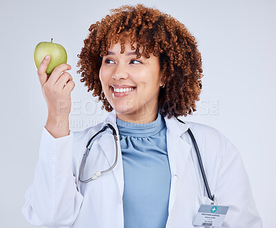Buy stock photo Doctor, happy woman and holding apple in white background, studio and vitamin c wellness. Medical employee, female nutritionist and smile with green fruits for nutrition, healthy food and vegan diet