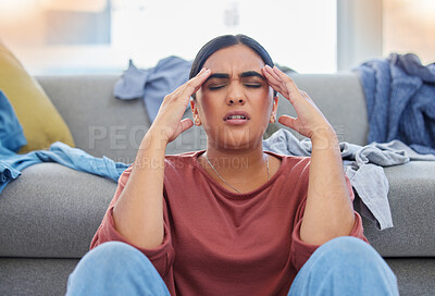 Buy stock photo Headache, stress and woman with depression from laundry in a living room, exhausted and unhappy in her home. Anxiety, migraine and female person frustrated with household, task or spring cleaning