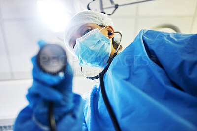 Buy stock photo Covid, surgery and a doctor with a light in the theater for a medical procedure or inspection. Hospital, healthcare and portrait of a surgeon or clinic worker with gear for an emergency consultation