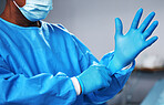 Doctor with gloves, health and surgeon with PPE, safety and protection from bacteria, operating room and closeup. Medical professional, surgery and treatment with person in hospital and healthcare