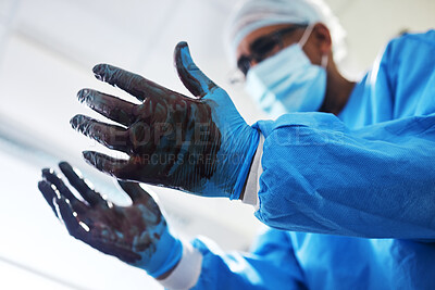 Buy stock photo Blood, gloves and operation with a doctor in the hospital emergency room or operating theatre for surgery. Hands, healthcare or medical with a male medicine professional in a clinic for a procedure