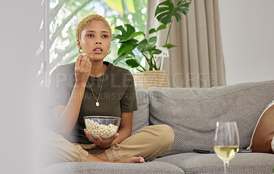 Buy stock photo Woman, popcorn and watch a movie, streaming online with service and relax at home on sofa. Female person, subscription and internet, watching drama film or series with cinema snack and television