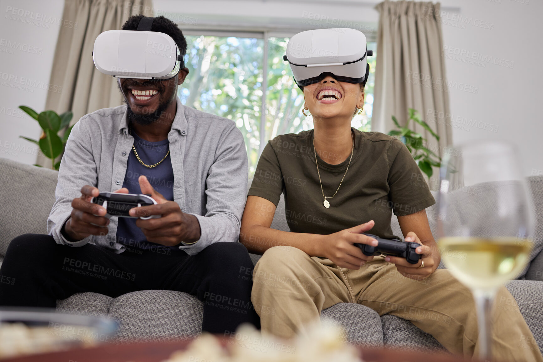 Buy stock photo Funny couple, vr and gaming on sofa in home living room, happy and laughing together. Virtual reality, couch and African man and woman play 3d game, metaverse and esports with futuristic technology.
