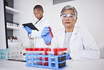 Science, blood and DNA with a doctor woman holding a laboratory sample for research or innovation. Healthcare, medical and study with a senior female scientist working in a lab for cure development