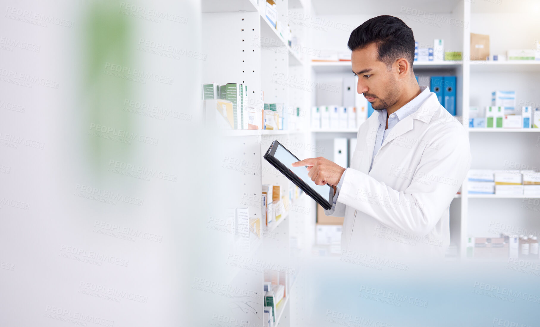 Buy stock photo Pharmacist, medicine and Asian man with tablet to check inventory, stock or healthcare for online prescription. Pharmacy, medical worker or employee with pills, health products or internet connection