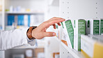Pharmacist hand, shelf and boxes with choice, packing stock and inventory inspection in shop. Pharmacy manager, package and product label for healthcare, pills and health with drugs in retail store