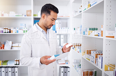 Buy stock photo Medicine inspection, pharmacy and man with a note for medical stock or healthcare in store. Retail, work and male Asian pharmacist reading information on a box of pills with a document for inventory