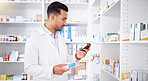 Pharmacist, medicine and man with bottle to check stock in pharmacy store. Medication, inventory and medical doctor reading label on pharmaceutical drugs, supplements and information for healthcare.
