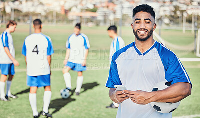 Buy stock photo Football player, phone and portrait at game on a field for sports and fitness app. Happy male soccer or athlete person outdoor for challenge, competition or motivation with online communication