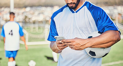 Buy stock photo Soccer field, phone and man hands for competition, training or fitness news, social media chat and blog. Football player or person typing on mobile app for sports information, health or goals check