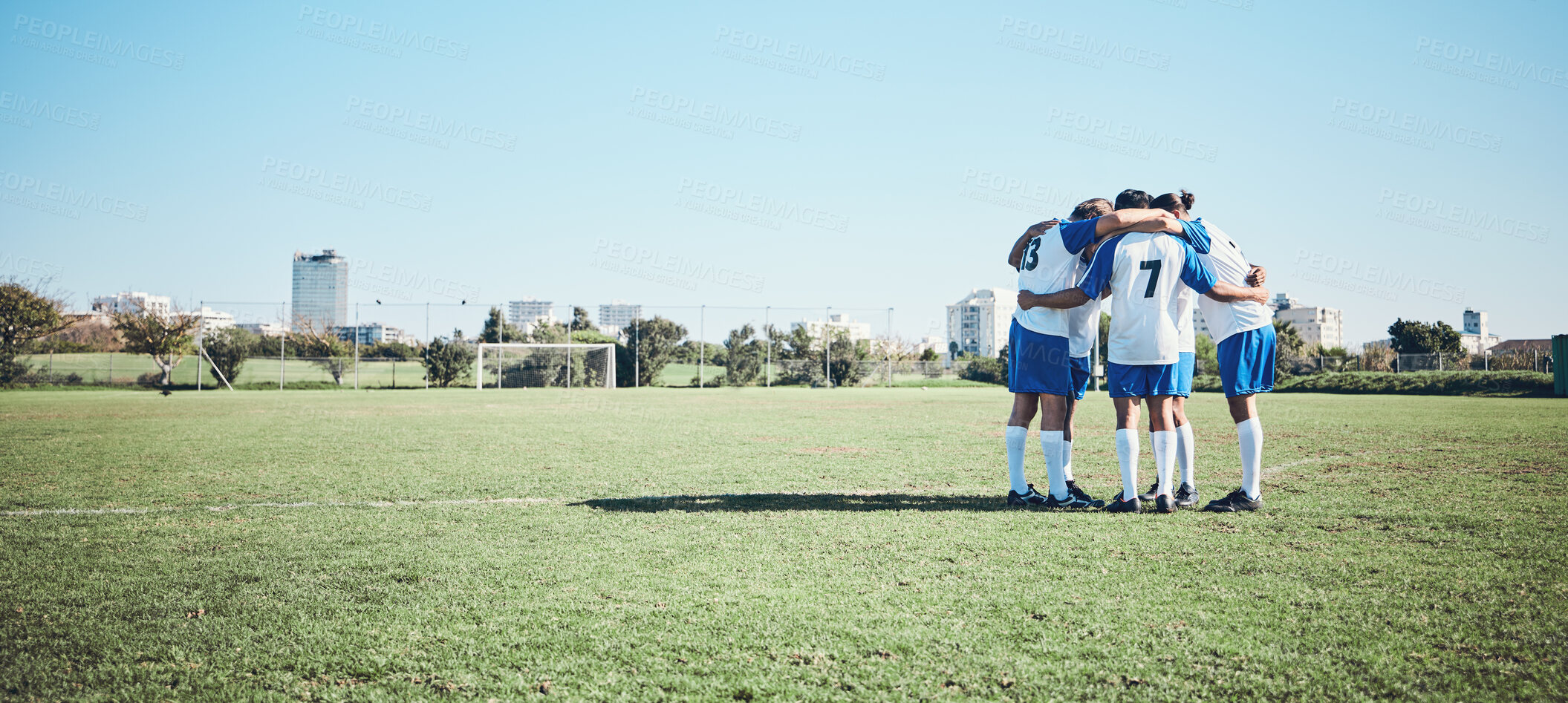 Buy stock photo Sports, mockup and a team of soccer players in a huddle on a field for motivation before a game. Football, fitness and training with man friends getting ready for competition on a pitch together