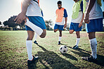 Stretching legs, football player and men training on a field for sports game and fitness. Male soccer team or athlete group together for challenge, workout or exercise outdoor on a grass pitch