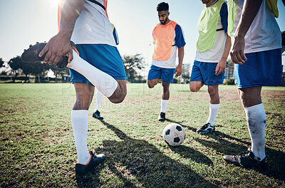 Buy stock photo Stretching legs, football player and men training on a field for sports game and fitness. Male soccer team or athlete group together for challenge, workout or exercise outdoor on a grass pitch