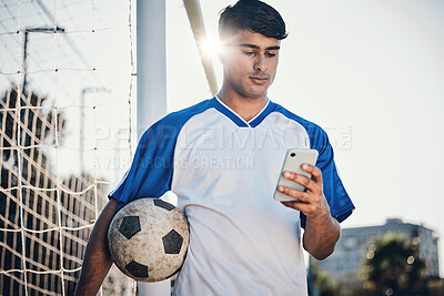 Buy stock photo Soccer ball, phone and man on field for competition, training or fitness news, social media chat and blog. Football player or person search on mobile app for sports information, health or goals check