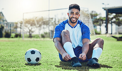 Buy stock photo Sports, man or soccer player tie shoes for training, fitness games and performance on stadium field. Portrait, happy indian athlete or lace football sneakers on grass pitch to prepare for competition