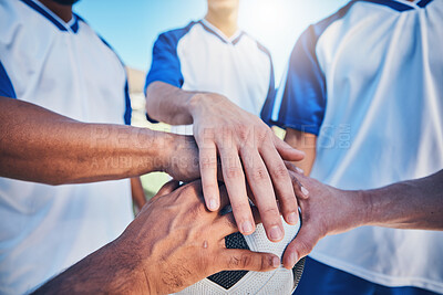 Buy stock photo Sports, huddle and football team with their hands together on the ball for motivation, empowerment or unity. Fitness, group and athletes or soccer players in a circle before game, match or tournament