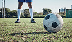 Sports, soccer ball and feet or shoes of person to kick on field, fitness training or ready for a goal on grass. Football, sneakers and athlete in exercise, competition or sport challenge for goals